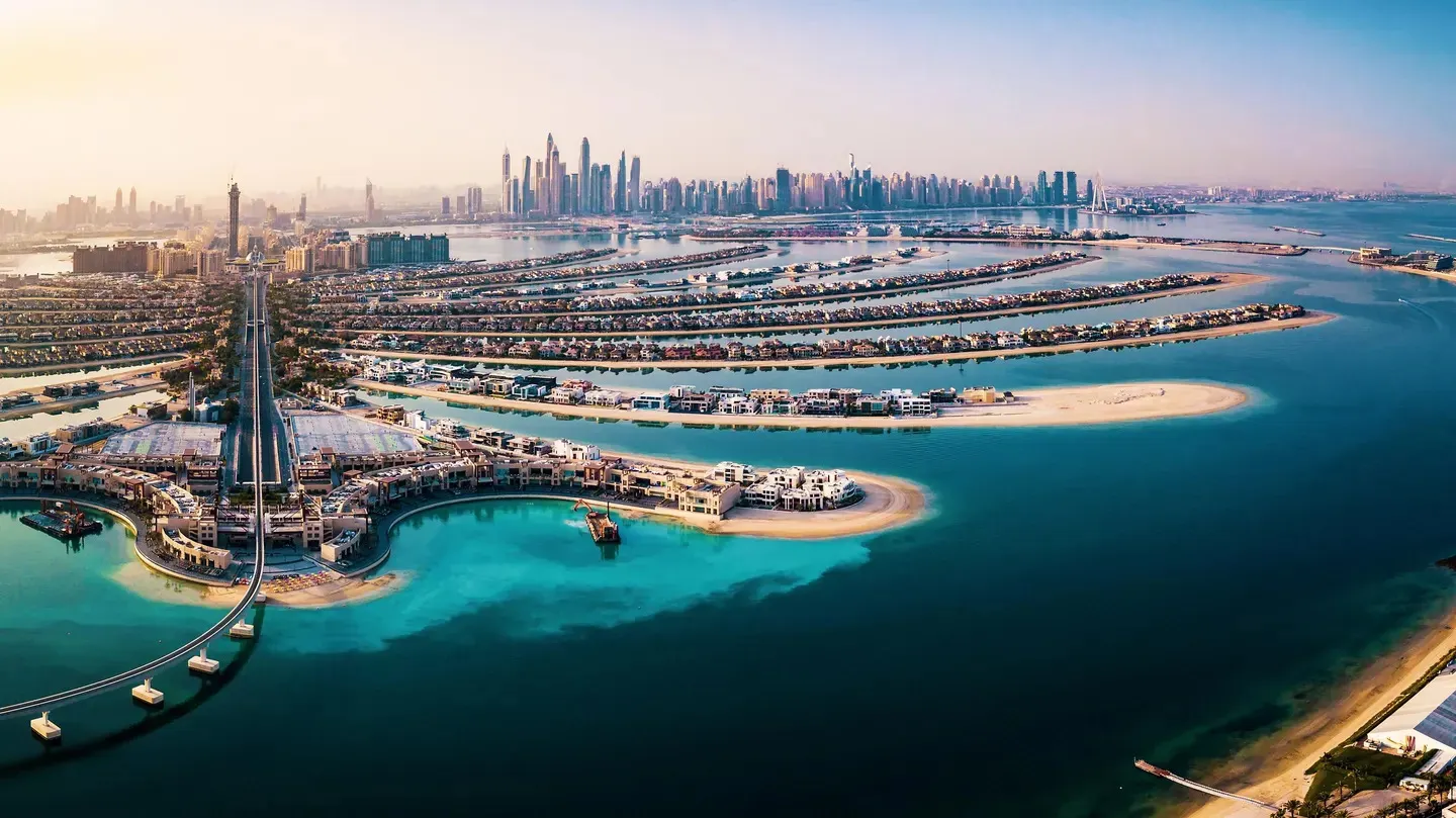 Aerial view of Palm Jumeirah and the Dubai skyline at golden hour