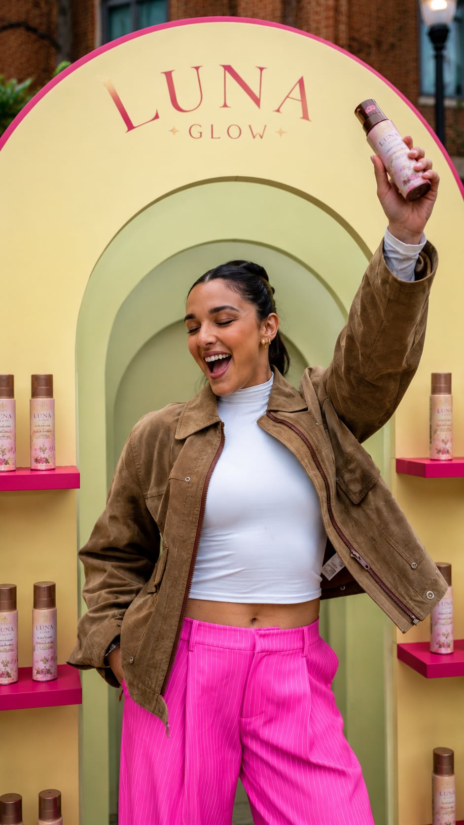 A creator holding a product at a Luna Glow pop-up.